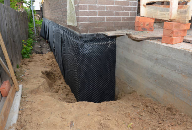 SJ Waterproofing Pros technician performing targeted Wet Basement Repair assessment in Gobles, MI